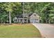 Charming home with a well-manicured lawn and lush greenery, featuring a two-car garage and inviting front porch at 2130 Hampton Se Trl, Conyers, GA 30013