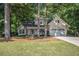 Charming home with a well-manicured lawn and lush greenery, featuring a two-car garage and inviting front porch at 2130 Hampton Se Trl, Conyers, GA 30013