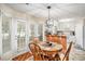 Charming eat-in kitchen with white cabinets and french doors to the backyard at 2130 Hampton Se Trl, Conyers, GA 30013