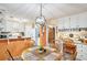 Open kitchen with white cabinetry, a peninsula, and a connected breakfast nook at 2130 Hampton Se Trl, Conyers, GA 30013