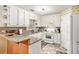 Bright kitchen featuring white cabinets, granite countertops, and modern appliances at 2130 Hampton Se Trl, Conyers, GA 30013