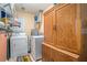 Functional laundry room with washer, dryer, and ample storage cabinets at 2130 Hampton Se Trl, Conyers, GA 30013