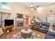Spacious living room with a brick fireplace, TV, hardwood floors, and comfortable furniture, ideal for Gathering gatherings at 2130 Hampton Se Trl, Conyers, GA 30013