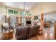 Sun-filled living room with a brick fireplace, large windows, hardwood floors, and comfortable seating, perfect for entertaining at 2130 Hampton Se Trl, Conyers, GA 30013