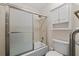Tub/shower combo with glass doors and light fixtures at 4116 River Cliff Chase Se, Marietta, GA 30067
