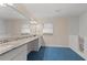 Bright bathroom with blue floor tile, a long vanity, and walk-in tub at 4116 River Cliff Chase Se, Marietta, GA 30067