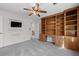 Bedroom featuring built-in shelving unit, plush carpet, and a ceiling fan at 4116 River Cliff Chase Se, Marietta, GA 30067