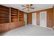 Bedroom featuring built-in shelving, wood-paneled walls, and neutral carpeting, offering a cozy retreat at 4116 River Cliff Chase Se, Marietta, GA 30067