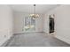 Bright dining room with modern chandelier, neutral carpeting, and access to the kitchen, perfect for entertaining at 4116 River Cliff Chase Se, Marietta, GA 30067