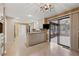 Bright kitchen featuring tile floors, breakfast bar, and access to a sunroom through sliding glass doors at 4116 River Cliff Chase Se, Marietta, GA 30067