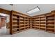 Spacious recreation room with lots of built-in wooden shelving and neutral tile flooring at 4116 River Cliff Chase Se, Marietta, GA 30067
