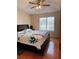 Comfortable bedroom with ample natural light, ceiling fan, and hardwood floors at 2315 Oakland Spring Dr, Snellville, GA 30039