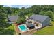 Expansive backyard with a sparkling pool, cabana, detached garage, and lush greenery at 3906 Laurens Ln, Snellville, GA 30039