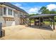 Backyard with garage, deck with stairs, and covered patio with table and chairs at 3906 Laurens Ln, Snellville, GA 30039
