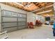 Unfinished basement space with garage doors, lighting, and seating at 3906 Laurens Ln, Snellville, GA 30039