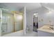 Bathroom featuring a shower with gold trim, a double vanity, and an adjacent toilet at 3906 Laurens Ln, Snellville, GA 30039