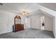 Spacious bedroom featuring grey carpet, a ceiling fan, and a classic wood dresser with a large mirror at 3906 Laurens Ln, Snellville, GA 30039