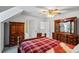 Well-lit bedroom with neutral walls, wood furnishings, grey carpet, and a comfortable bed at 3906 Laurens Ln, Snellville, GA 30039