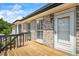 Wooden deck with brick siding, windows with white trim, and a white entry door at 3906 Laurens Ln, Snellville, GA 30039