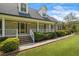 Inviting home featuring a covered front porch, well-kept landscaping, and brick facade at 3906 Laurens Ln, Snellville, GA 30039