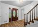 Bright foyer with hardwood floors, decorative front door, and staircase access at 3906 Laurens Ln, Snellville, GA 30039