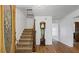 Grand foyer featuring hardwood floors, staircase, and a classic grandfather clock at 3906 Laurens Ln, Snellville, GA 30039