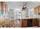 Open concept kitchen with wood cabinets, granite counters, stainless appliances and a tile floor at 3906 Laurens Ln, Snellville, GA 30039
