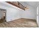 Open living room with high ceilings, hardwood floors, a ceiling fan, and balcony with railing above at 3906 Laurens Ln, Snellville, GA 30039