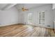 Bright living room featuring hardwood floors, a ceiling fan, and lots of natural light from two shuttered windows at 3906 Laurens Ln, Snellville, GA 30039