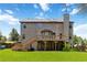 Expansive backyard with a large wooden deck, covered patio, and mature landscaping at 4249 Caveat Ct, Fairburn, GA 30213