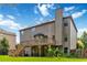 Expansive backyard with a large wooden deck, covered patio, and mature landscaping at 4249 Caveat Ct, Fairburn, GA 30213