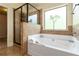 Bathroom featuring a soaking tub and glass-enclosed shower at 4249 Caveat Ct, Fairburn, GA 30213