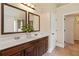 Bathroom featuring a double sink vanity, a large mirror, and ceramic tile flooring at 4249 Caveat Ct, Fairburn, GA 30213