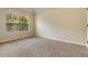 Bright, carpeted bedroom features a large window, neutral paint, and ample space at 4249 Caveat Ct, Fairburn, GA 30213