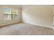 Carpeted bedroom features a large window and natural light, creating a tranquil space at 4249 Caveat Ct, Fairburn, GA 30213