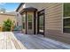 View of a wooden deck with an entry door and several windows attached to a two-story home at 4249 Caveat Ct, Fairburn, GA 30213