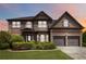 Inviting home features a manicured front yard, brick facade, and two-car garage at 4249 Caveat Ct, Fairburn, GA 30213