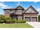 Beautiful two-story brick home with a well-manicured lawn and mature landscaping at 4249 Caveat Ct, Fairburn, GA 30213