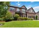 Beautiful two-story brick home with a well-manicured lawn and mature landscaping at 4249 Caveat Ct, Fairburn, GA 30213