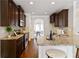 Stylish kitchen features granite countertops, stainless appliances, and dark wood cabinets at 4249 Caveat Ct, Fairburn, GA 30213