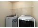 Convenient laundry room with a washer, dryer, and overhead storage shelving at 4249 Caveat Ct, Fairburn, GA 30213