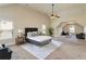 Bright main bedroom featuring plush carpeting, a ceiling fan, and a sitting area at 4249 Caveat Ct, Fairburn, GA 30213
