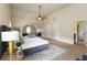 Large main bedroom with a sitting area, ceiling fan, and ensuite bathroom access at 4249 Caveat Ct, Fairburn, GA 30213