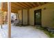 View of a concrete patio underneath a wooden deck with a back door and swing at 4249 Caveat Ct, Fairburn, GA 30213