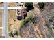 Overhead view of a residential property featuring a well-kept lawn, mature trees, and a charming brick house with brown roof at 149 Crown Glen Way, Stockbridge, GA 30281