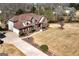 Aerial view of a spacious property with a well-maintained lawn, mature trees, and a charming two-story brick home at 149 Crown Glen Way, Stockbridge, GA 30281
