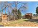 Large backyard featuring mature trees, a wooden playhouse and a multi-level back deck at 149 Crown Glen Way, Stockbridge, GA 30281