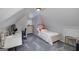Bedroom with a white bed, desk and dresser with sloped ceilings at 149 Crown Glen Way, Stockbridge, GA 30281