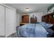 Cozy bedroom features a plush blue comforter, dark wood furniture, and double closets, creating a relaxing retreat at 149 Crown Glen Way, Stockbridge, GA 30281