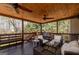 Relaxing covered deck with comfortable seating, wood floors, and ceiling fans at 149 Crown Glen Way, Stockbridge, GA 30281